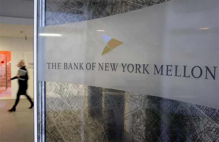 A woman walks past a logo at the office of the Bank of New York Mellon in Brussels