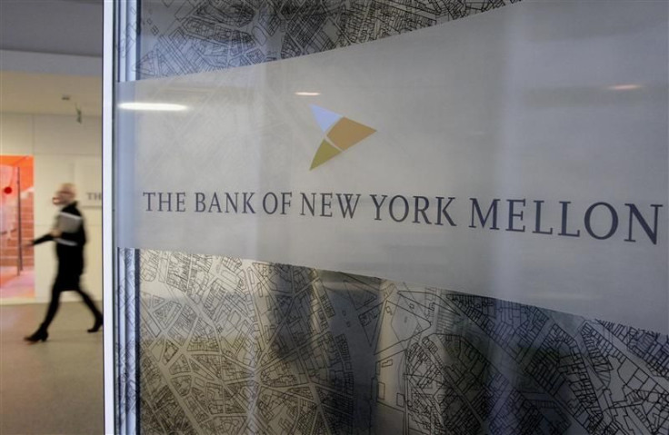 A woman walks past a logo at the office of the Bank of New York Mellon in Brussels