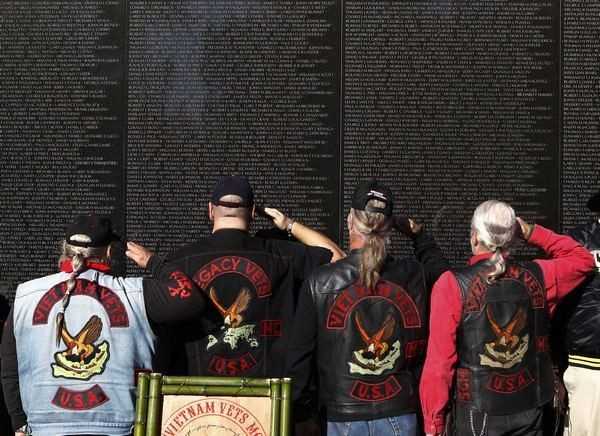 Veterans salute at the Vietnam Veteran's Memorial on Veteran's Day in Washington, November 11, 2010.