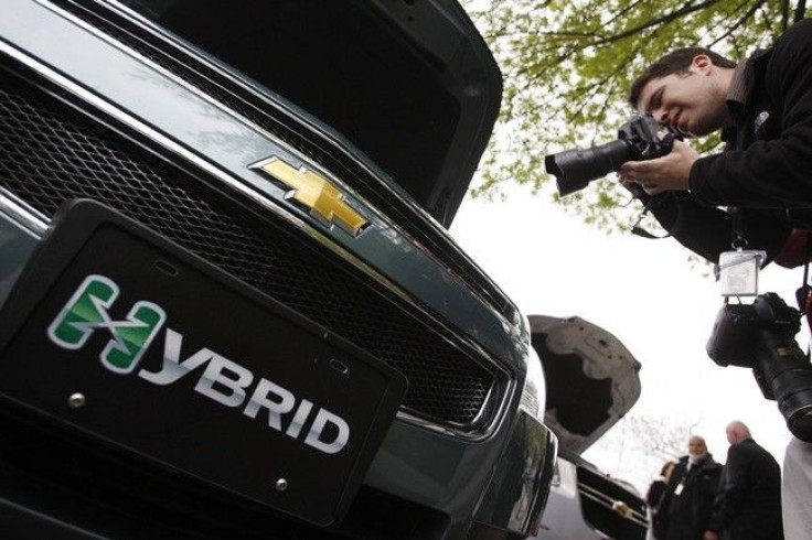 A photographer takes a picture of a Chevy Malibu hybrid car on display on West Executive Drive at the White House in Washington April 22, 2009.