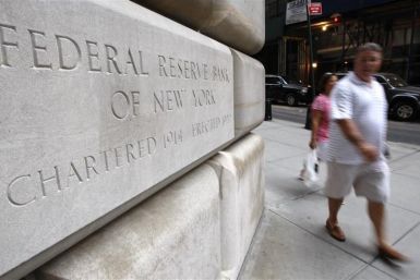 People walk past the Federal Reserve building in New York