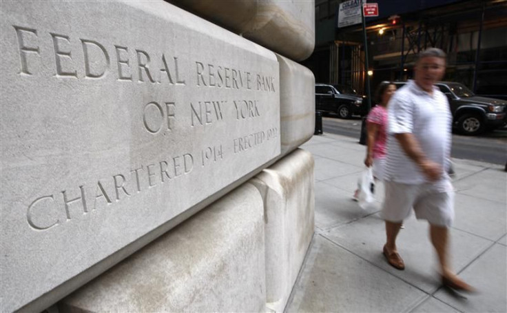 People walk past the Federal Reserve building in New York