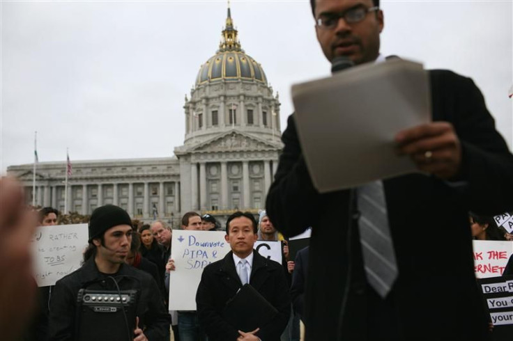 San Francisco Board of Supervisors president Chiu listens as Jay Nath, city&#039;s chief innovation officer, speaks during a protest of SOPA at City Hall in San Francisco