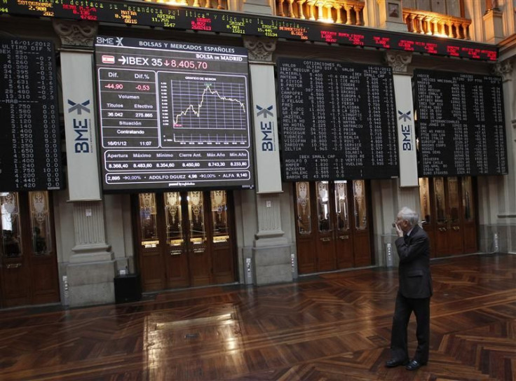 A trader looks at the stock index boards at Madrid&#039;s bourse