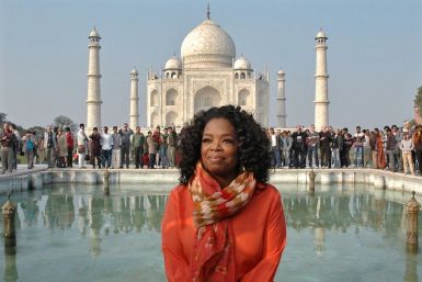 Entertainment host Oprah Winfrey poses for pictures in front of the historic Taj Mahal during her visit to the northern Indian city of Agra