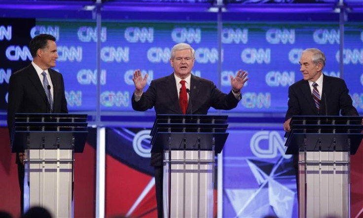 Republican presidential candidate Gingrich speaks as Romney and Paul look on during the Republican presidential candidates debate