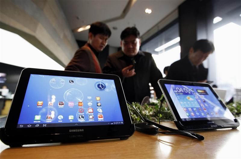 Customers look at Samsung Electronics Galaxy Tab tablet computers at a store in Seoul