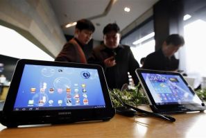 Customers look at Samsung Electronics' Galaxy Tab tablet computers at a store in Seoul