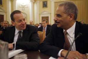 U.S. Attorney General Holder chats with Assistant Attorney General Breuer before their testimony on the second day of the Financial Crisis Inquiry Commission hearing on Capitol Hill in Washington