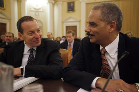 U.S. Attorney General Holder chats with Assistant Attorney General Breuer before their testimony on the second day of the Financial Crisis Inquiry Commission hearing on Capitol Hill in Washington