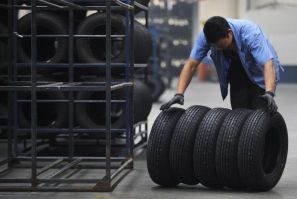 An employee moves tires at a tire factory