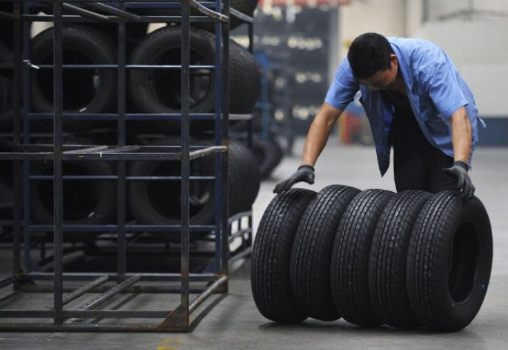 An employee moves tires at a tire factory