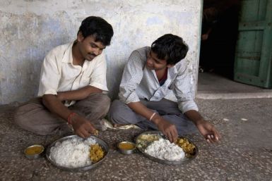 Unmarried men eat lunch together in the remote village of Siyani, India