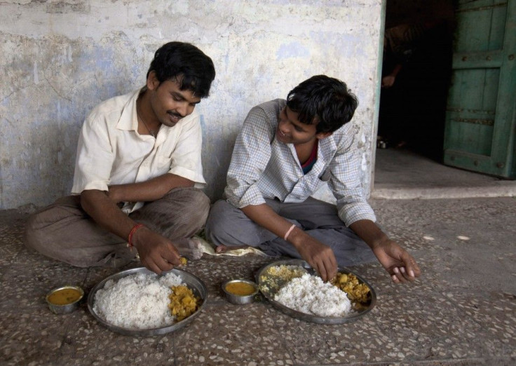 Unmarried men eat lunch together in the remote village of Siyani, India