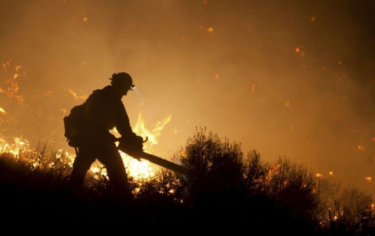 Crew member from Nevada Department of Forestry works to control Washoe Drive fire near home off Highway 395 in Washoe City