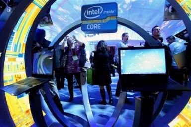 A woman takes a photo of ultrabooks at the Intel booth during the 2012 International Consumer Electronics Show (CES) in Las Vegas, Nevada January 10, 2012.