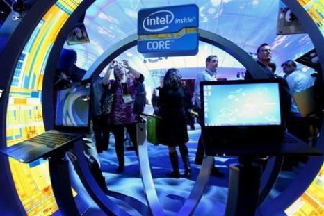 A woman takes a photo of ultrabooks at the Intel booth during the 2012 International Consumer Electronics Show (CES) in Las Vegas, Nevada January 10, 2012.