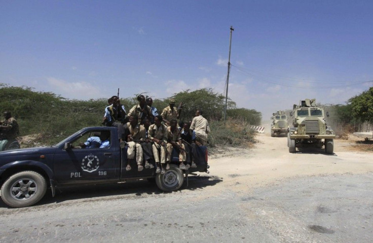 Somalia government soldiers and Ugandan peacekeepers from AMISOM patrol a road following an encounter with Islamist militia in Mogadishu