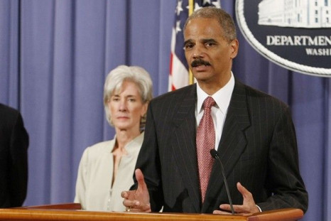 U.S. Attorney General Eric Holder (R) discusses the Healthcare Fraud and Prevention and Enforcement Action Team (HEAT) at the Justice Department in Washington, June 24, 2009. U.S. Secretary of HHS Kathleen is seen in the background.