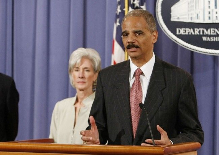 U.S. Attorney General Eric Holder (R) discusses the Healthcare Fraud and Prevention and Enforcement Action Team (HEAT) at the Justice Department in Washington, June 24, 2009. U.S. Secretary of HHS Kathleen is seen in the background.