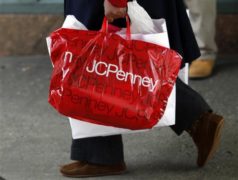A pedestrian walks with a shopping bag from a JC Penney department store in New York