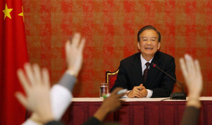 Chinese Premier Wen Jiabao reacts during a news conference in Doha