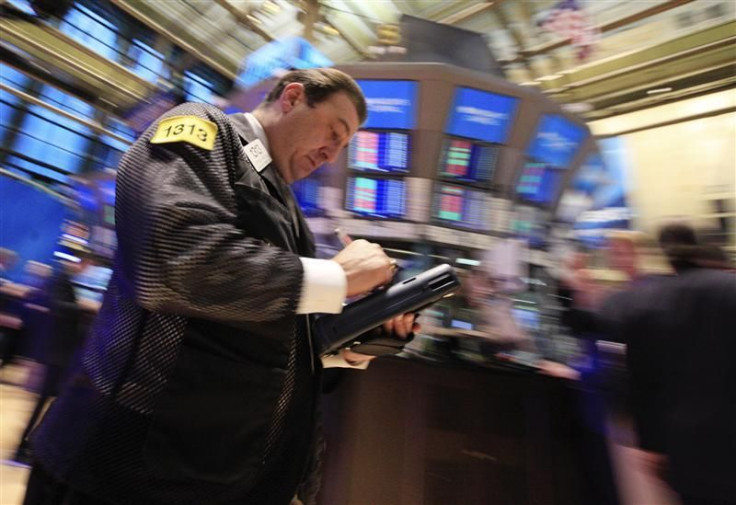 Traders work on the floor of the New York Stock Exchange January 20, 2012.