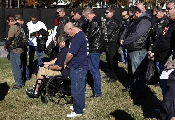 Veterans pray at the Vietnam Veterans Memorial on Veteran's Day in Washington, November 11, 2010.