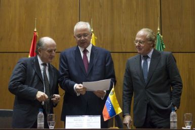Spanish Repsol&#039;s Chairman Antonio Brufauof, left, Venezuela&#039;s Energy Minister Rafael Ramirez, center, and Italian ENI CEO Paolo Scaroni attend an agreement-signing ceremony at the headquarters of the state-run oil company PDVSA in Caracas on Dec