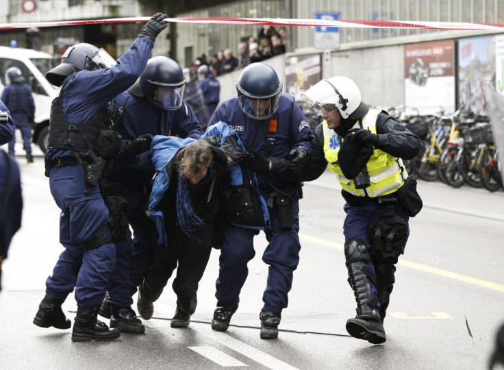 Swiss riot police remove an anti World Economic forum ( WEF) protestor during a demonstration in Bern January 21, 2012. The WEF will take place in Davos January 25 - 29.