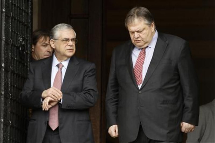 Greece&#039;s PM Papademos escorts Finance Minister Venizelos after a meeting in Athens