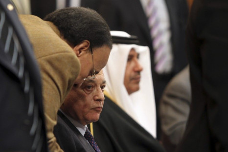 Arab League Secretary General Nabil Elaraby listens to his assistant during the Arab foreign ministers meeting in Cairo