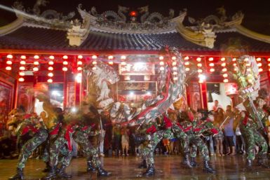 Soldiers perform dragon-dance in front of Tay Kei Sek temple in Semarang