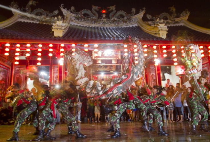 Soldiers perform dragon-dance in front of Tay Kei Sek temple in Semarang