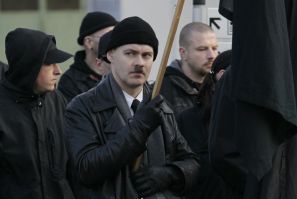 A neo-Nazi holds a black flag during an ultra right-wing rally in Remagen