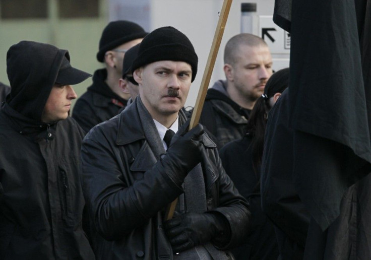 A neo-Nazi holds a black flag during an ultra right-wing rally in Remagen