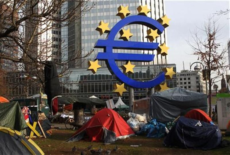 Tents of &#039;Occupy Frankfurt&#039; movement are pictured next to Euro currency sign sculpture in front of ECB headquarters in Frankfurt