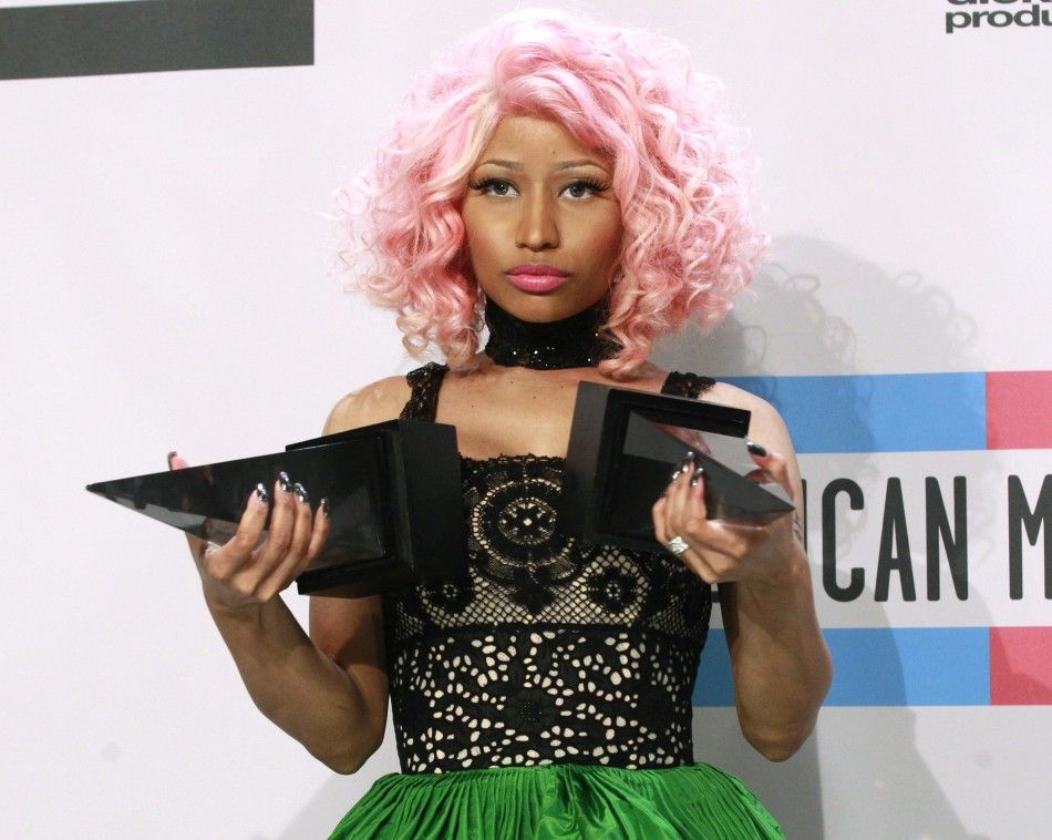 Nicki Minaj poses with her awards for Favorite RapHip Hop Artist and Favorite RapHip Hop album