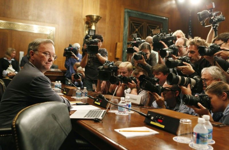 Executive Chairman of Google Eric Schmidt faces a wall of news photographers before a Senate Judiciary Subcommittee in Washington