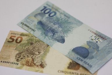 A photo illustration of new Brazilian R$50 and R$100 real currency notes after their launch in Brasilia