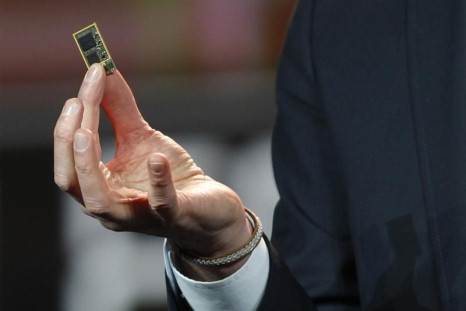 Hans Vestberg, president and CEO of Ericsson Group, holds a ST-Ericsson 4G LTE chip during his keynote address at the 2012 International CES in Las Vegas