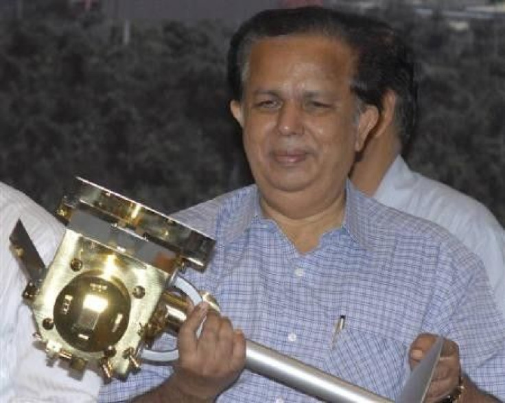 Former Chief of ISRO G. Madhavan Nair, holds a miniature of India&#039;s first unmanned moon mission &#039;Chandrayaan-1&#039; after its launch