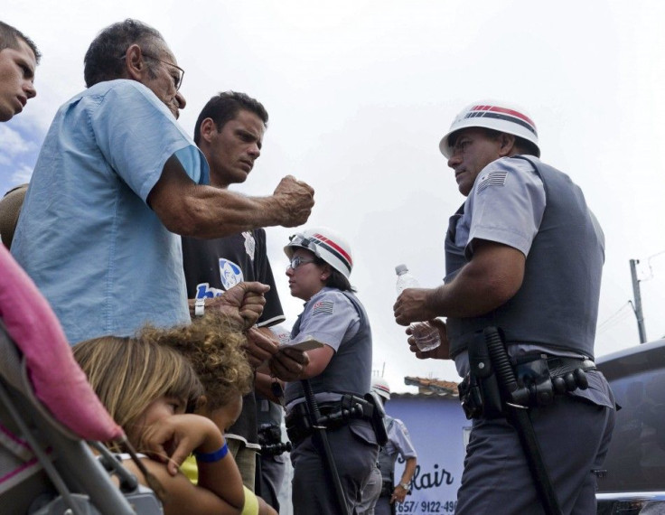 Residents of the Pinheirinho slum argue with police blocking access to their homes in Sao Jose dos Campos