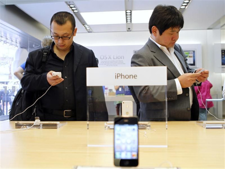 Customers try out the iPhone 4S at the Apple retail store in San Francisco