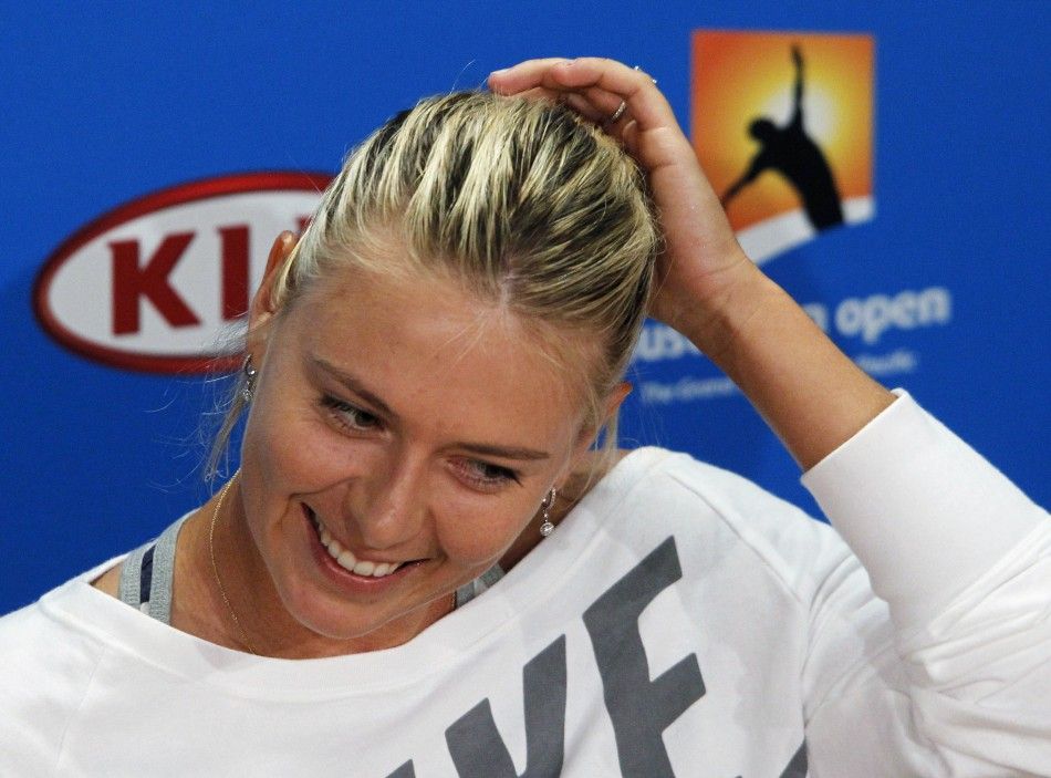 Maria Sharapova of Russia adjusts her hair during a news conference before the Australian Open tennis tournament in Melbourne