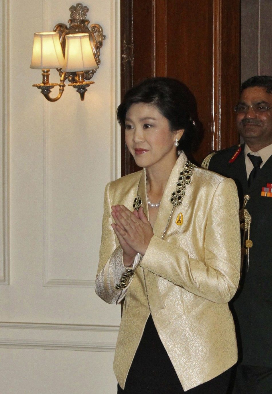 Thailand039s PM Shinawatra gestures to Indian President Patil upon her arrival for their meeting in New Delhi