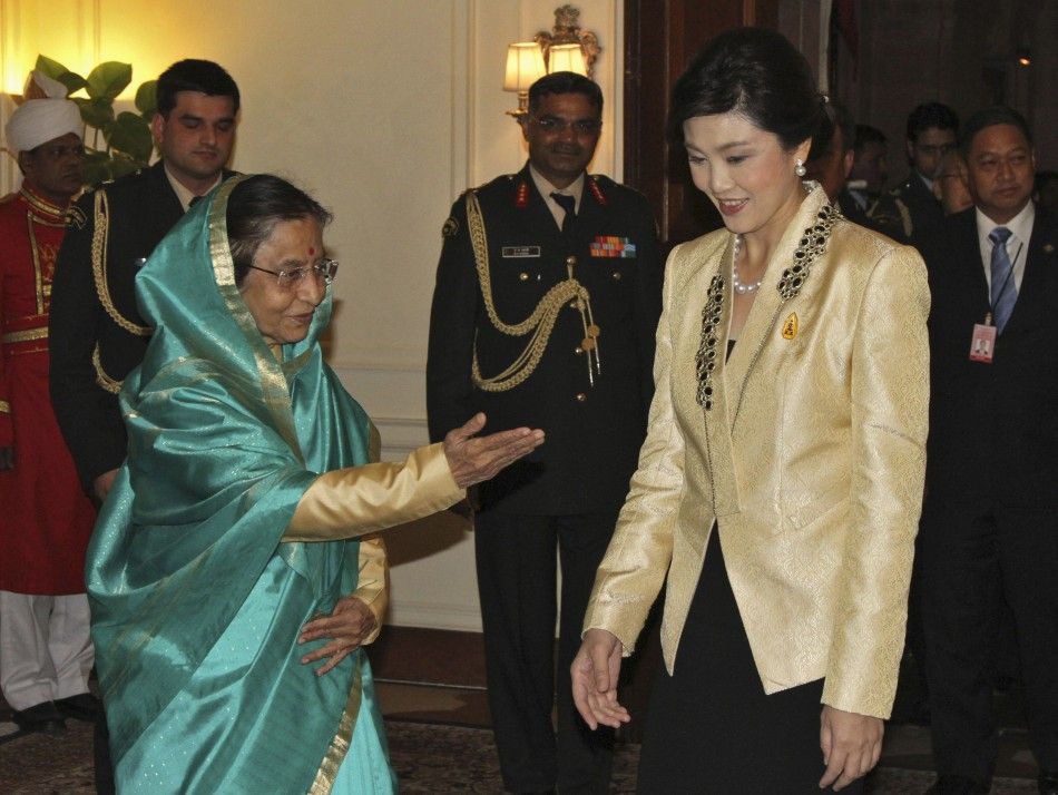 Indian President Patil gestures to Thailand039s PM Shinawatra before their meeting in New Delhi