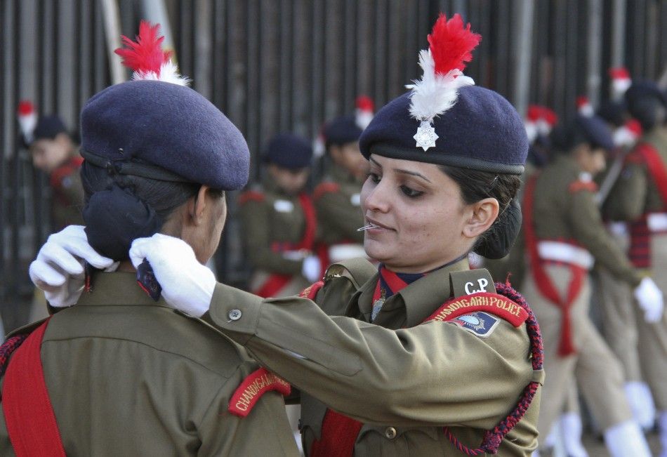 An Indian policewoman adjusts her colleague039s dress