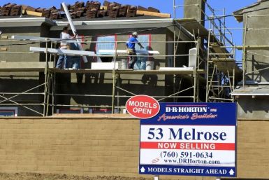 Construction workers continue work on a new subdivision of homes in San Marcos, California