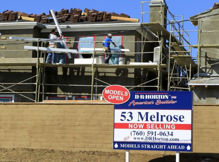 Construction workers continue work on a new subdivision of homes in San Marcos, California